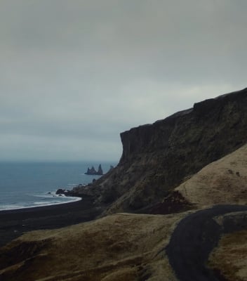 The mountainous Icelandic landscape meets the sea. 
