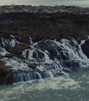 Waves crashing down on rocks and into the sea in Iceland